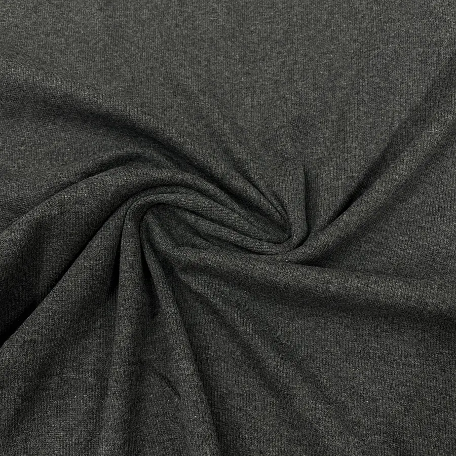 Close-up of dark gray stretch fabric gathered into soft folds and a central twist.